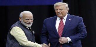 Prime Minister Narendra Modi and President Donald Trump shake hands after introductions during the "Howdi Modi"
